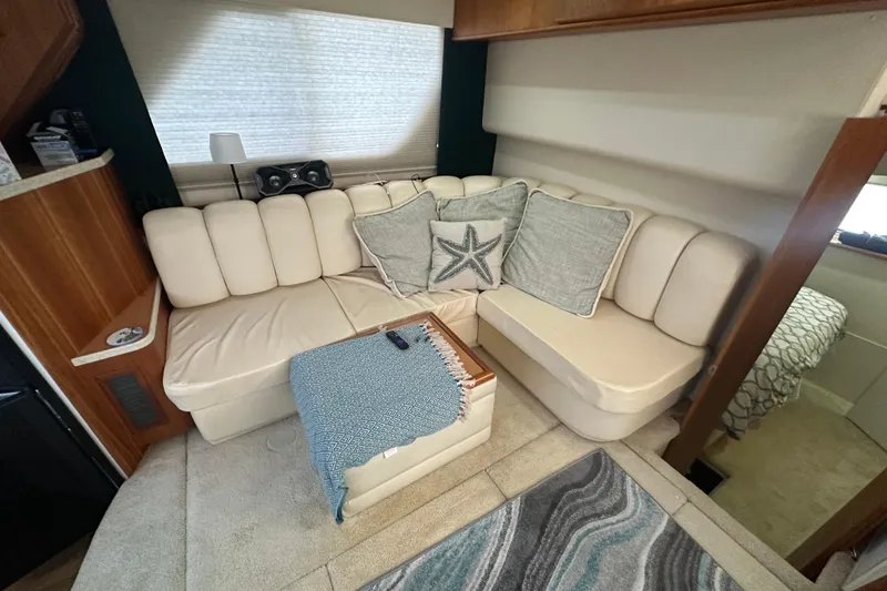 Slide: The Image of 1998 Silverton 372 Motor Yacht bedroom with cozy bed, window, and bathroom access. - 15