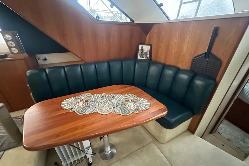 Slide: The Image of 1998 Silverton 372 Motor Yacht interior with cozy seating and decorative pillows. - 17