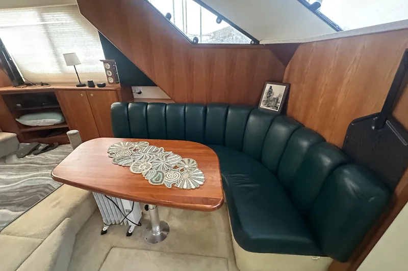 Slide: The Image of Interior of 1998 Silverton 372 Motor Yacht with beige sofa and decorative pillows. - 18