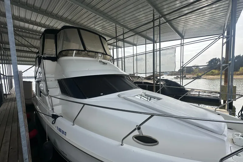 Slide: The Image of 1998 Silverton 372 Motor Yacht docked under a covered marina. - 3