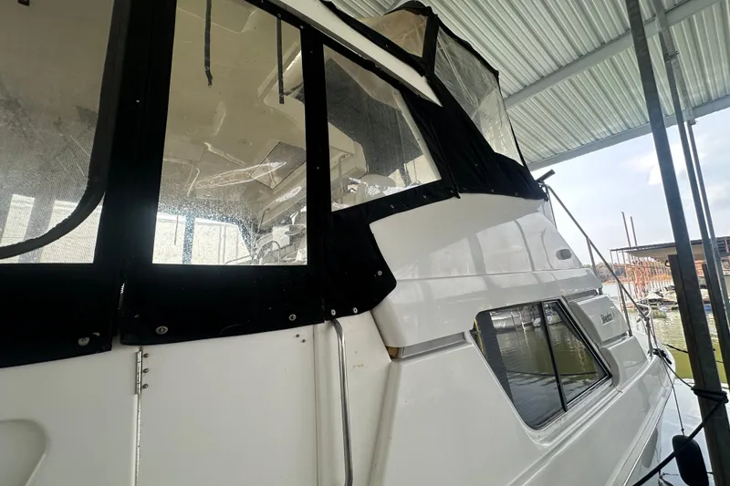 Slide: The Image of 1998 Silverton 372 Motor Yacht docked in marina, covered with protective canopy. - 5