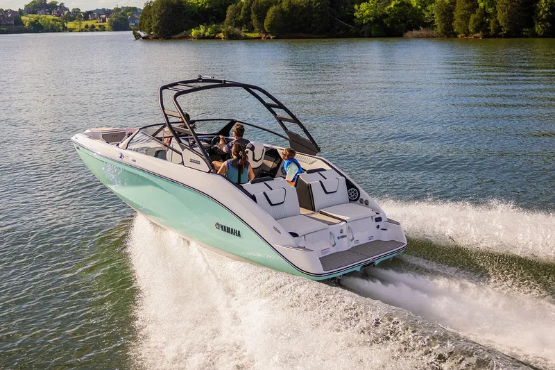 Slide: The Image of Manufacturer Provided Image: 2026 Yamaha Boats 222S cruising on a scenic lake with passengers enjoying the ride. - 2