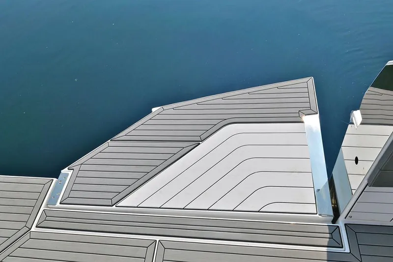 Slide: The Image of 2021 Cruisers Yachts 42 GLS OB swim platform with sleek, modern design on calm water. - 10
