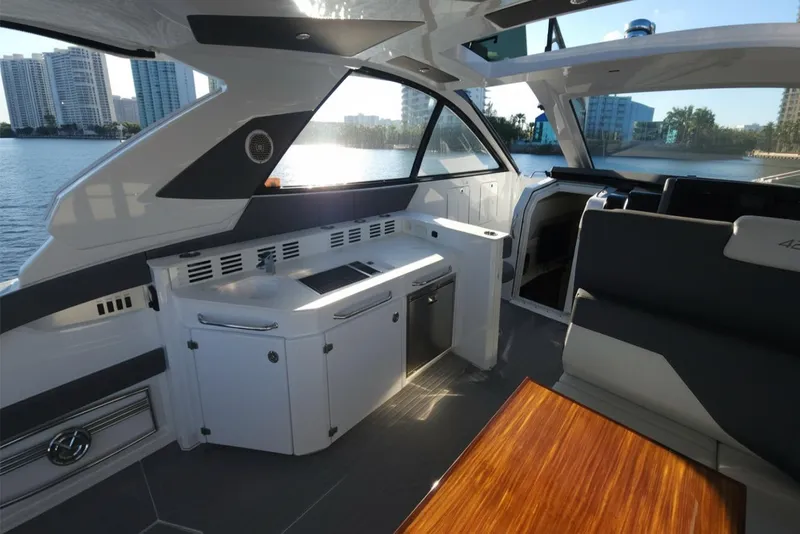 Slide: The Image of Interior of 2021 Cruisers Yachts 42 GLS OB with modern design and waterfront view. - 14