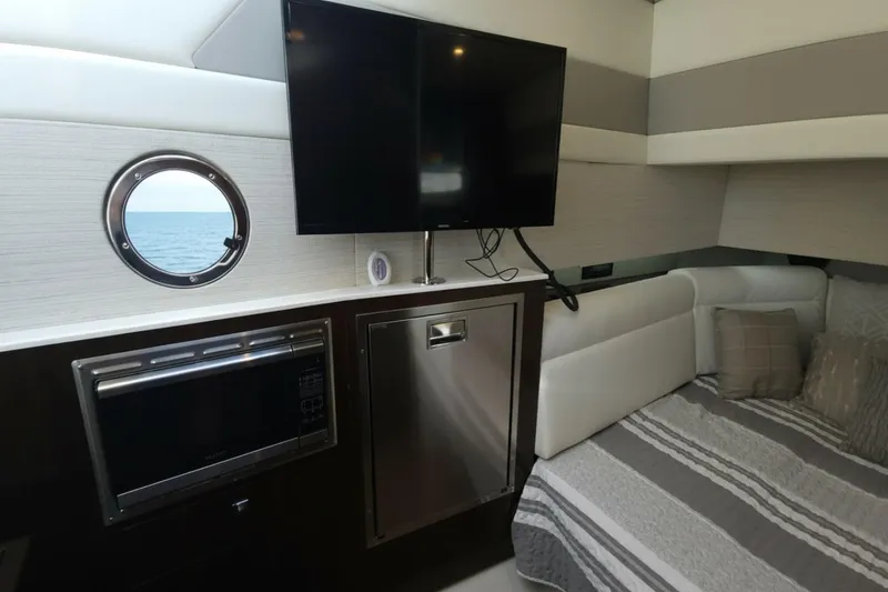 Slide: The Image of Interior of 2021 Cruisers Yachts 42 GLS OB with TV, microwave, and bed. - 28