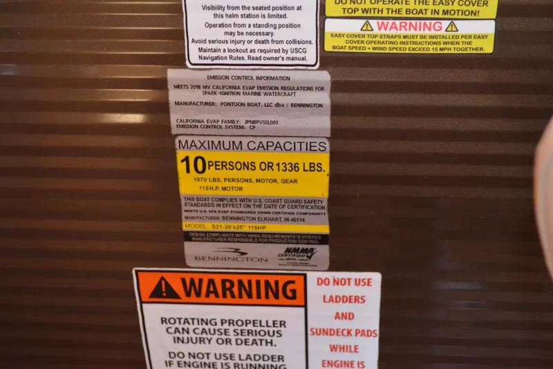 Slide: The Image of Warning labels and capacity information on a 2018 Bennington 21 SSRX boat. - 13