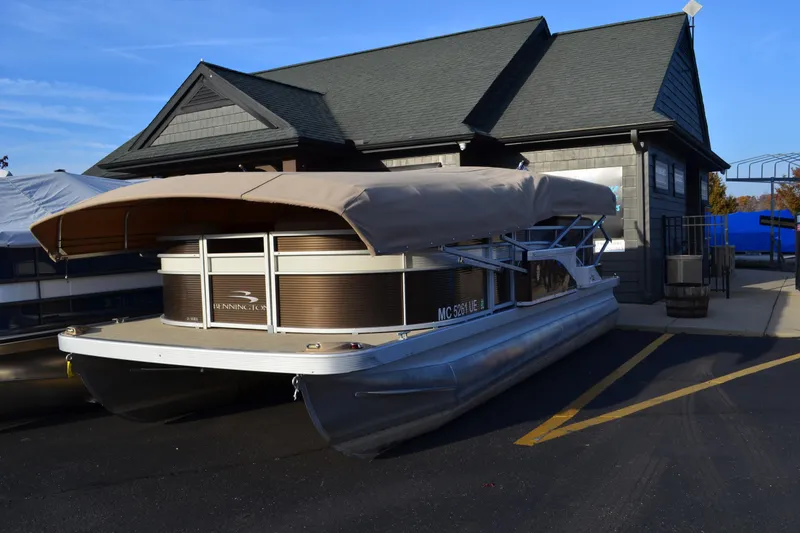 Slide: The Image of 2018 Bennington 21 SSRX pontoon boat parked near a building. - 3