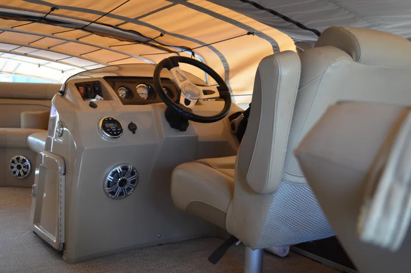 Slide: The Image of Interior of a 2018 Bennington 21 SSRX pontoon boat with steering console and seating. - 4