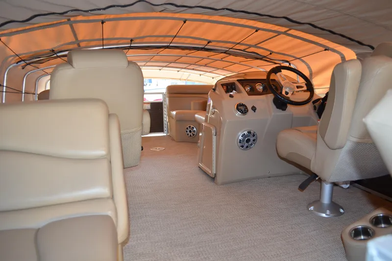 Slide: The Image of Interior of 2018 Bennington 21 SSRX pontoon boat with beige seating and covered helm. - 5