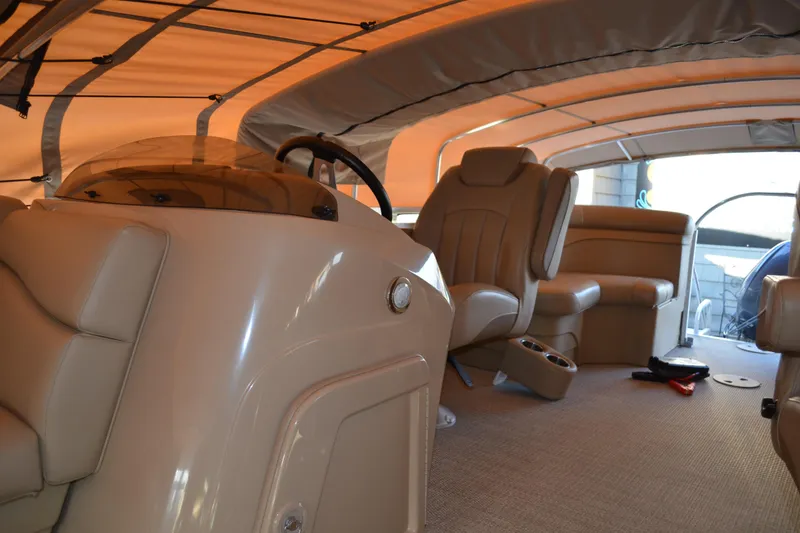 Slide: The Image of 2018 Bennington 21 SSRX pontoon boat interior with tan seating and canopy. - 9