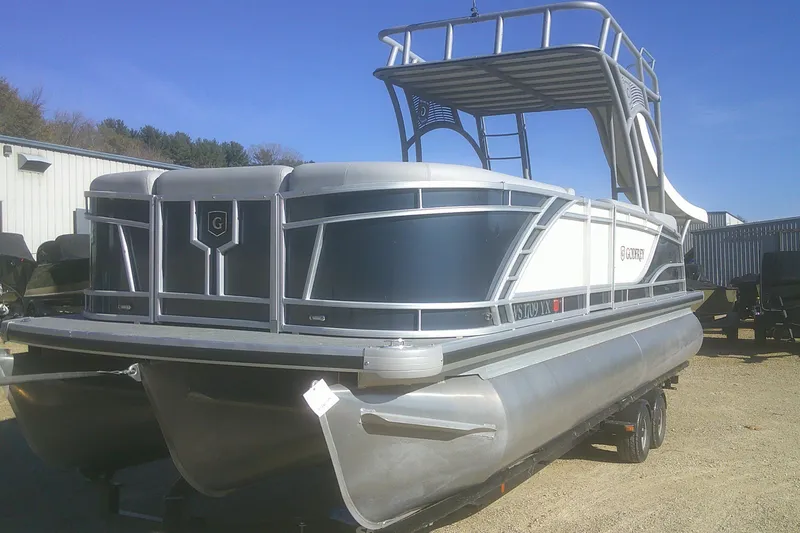 Slide: The Image of 2024 Godfrey Monaco 255 SD pontoon boat with upper deck and slide, parked outdoors. - 13