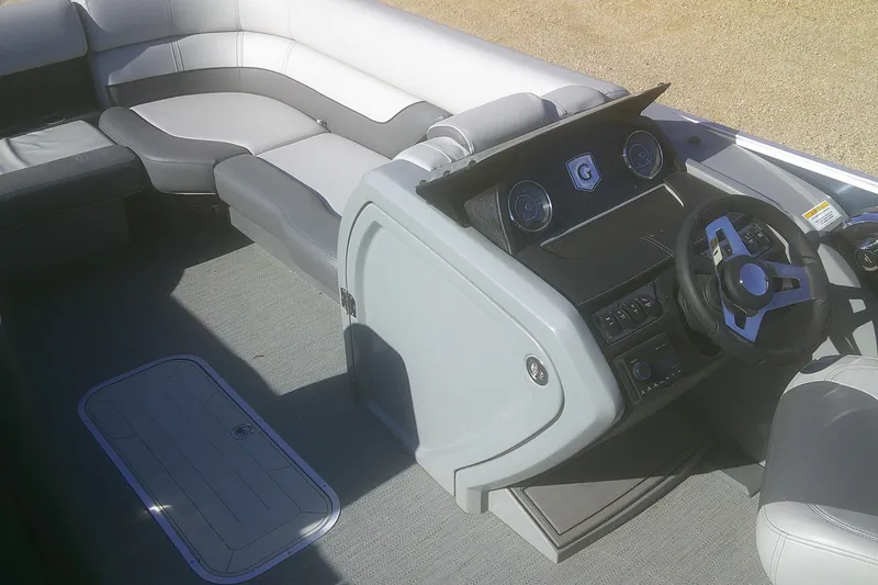 Slide: The Image of 2024 Godfrey Monaco 255 SD boat interior with modern steering console and seating. - 6