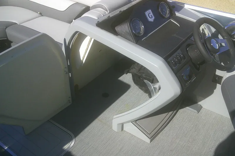 Slide: The Image of 2024 Godfrey Monaco 255 SD boat interior with steering console and seating. - 8