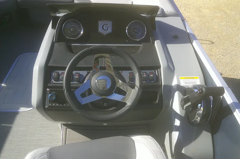 Slide: The Image of 2024 Godfrey Monaco 255 SD boat dashboard with steering wheel and controls. - 9