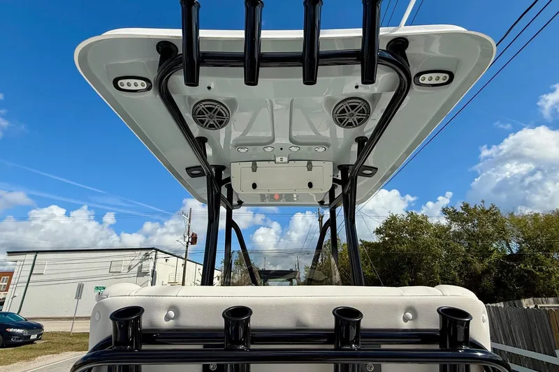 Slide: The Image of 2026 Sea Hunt BX 22 BR boat with T-top and rod holders under a clear blue sky. - 12