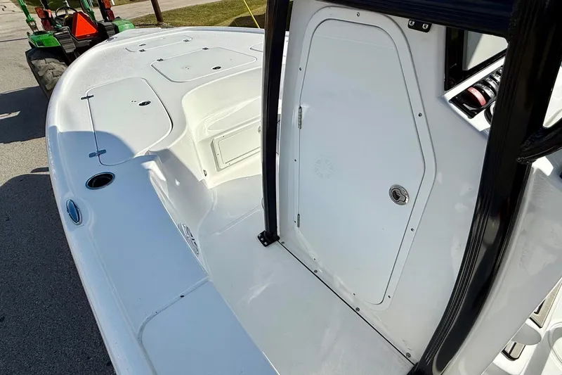 Slide: The Image of 2026 Sea Hunt BX 22 BR boat deck with storage compartments and console door. - 13