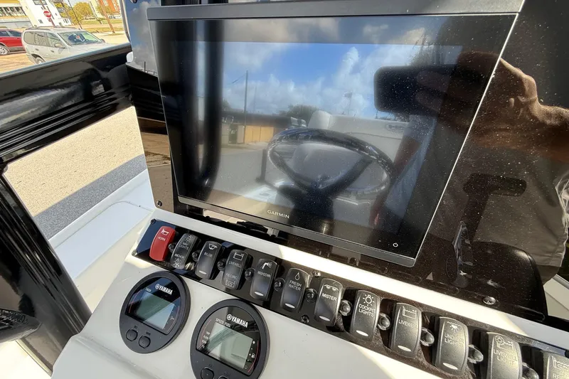 Slide: The Image of Control panel of 2026 Sea Hunt BX 22 BR boat with Garmin display and Yamaha gauges. - 18