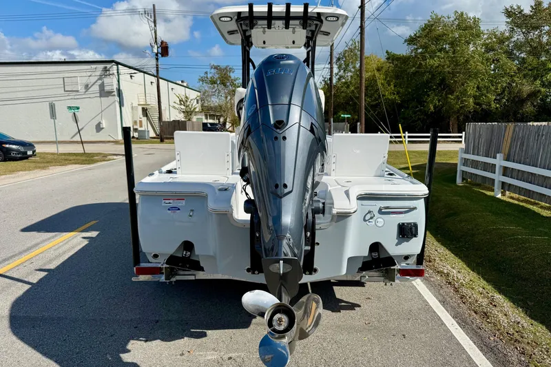 Slide: The Image of 2026 Sea Hunt BX 22 BR boat with powerful outboard motor on a sunny street. - 3