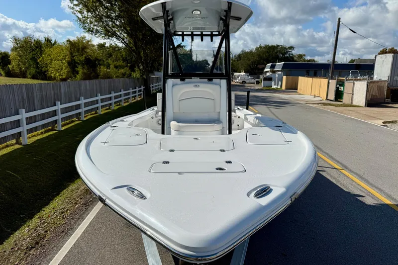 Slide: The Image of 2026 Sea Hunt BX 22 BR boat on a road, showcasing sleek design and spacious deck. - 6
