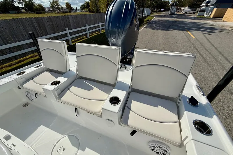 Slide: The Image of 2026 Sea Hunt BX 22 BR boat with three cushioned seats and cup holders. - 7