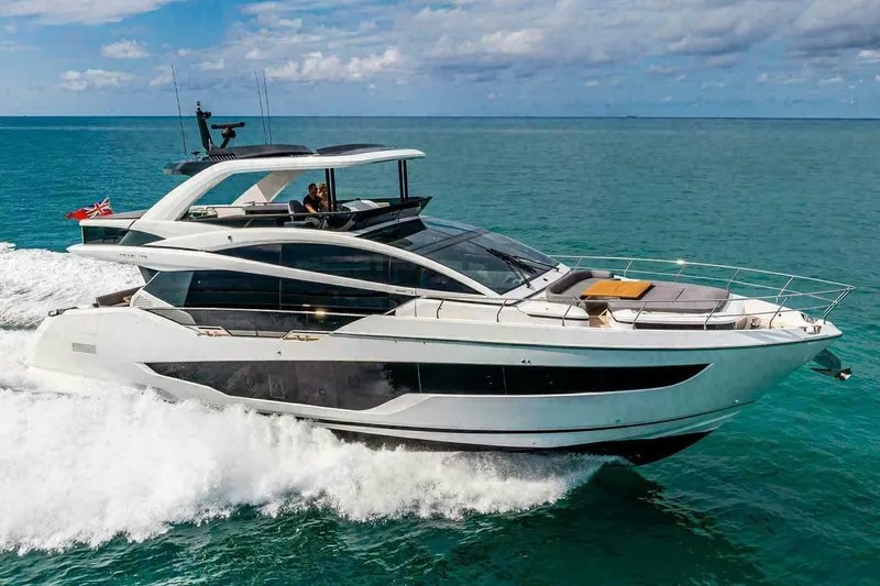 The Image of Luxurious 2025 Pearl 72 yacht cruising near waterfront mansions and palm trees. - 0