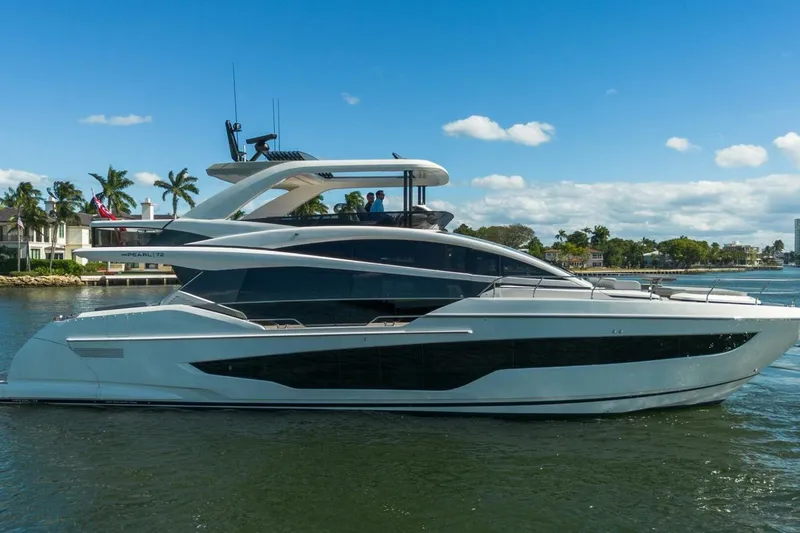 Slide: The Image of Luxurious 2025 Pearl 72 yacht cruising on a sunny day, surrounded by palm trees and waterfront homes. - 50