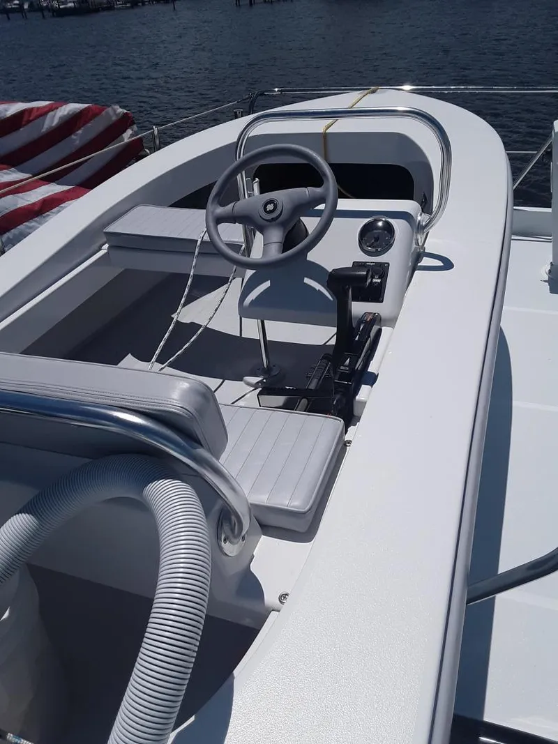 Slide: The Image of 2024 Ultra Lite Tenders Rigged 380 boat interior with steering wheel and seating. - 9