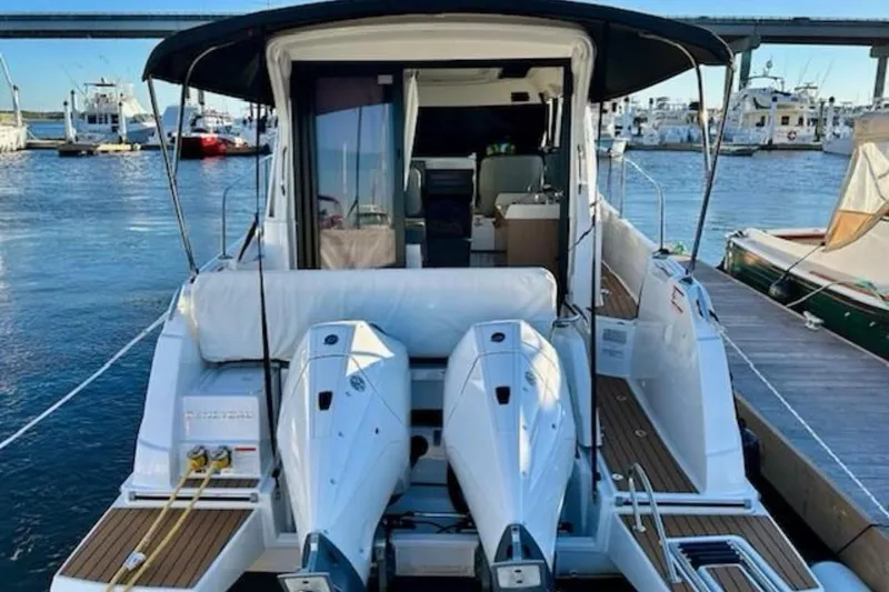 Slide: The Image of 2024 Beneteau Antares 9 boat docked with twin engines, rear view. - 1