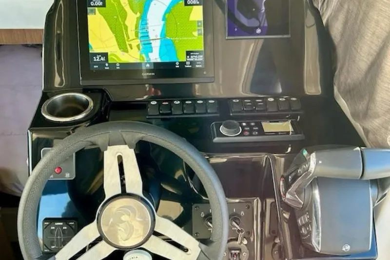 Slide: The Image of 2024 Beneteau Antares 9 helm with navigation display and controls. - 13