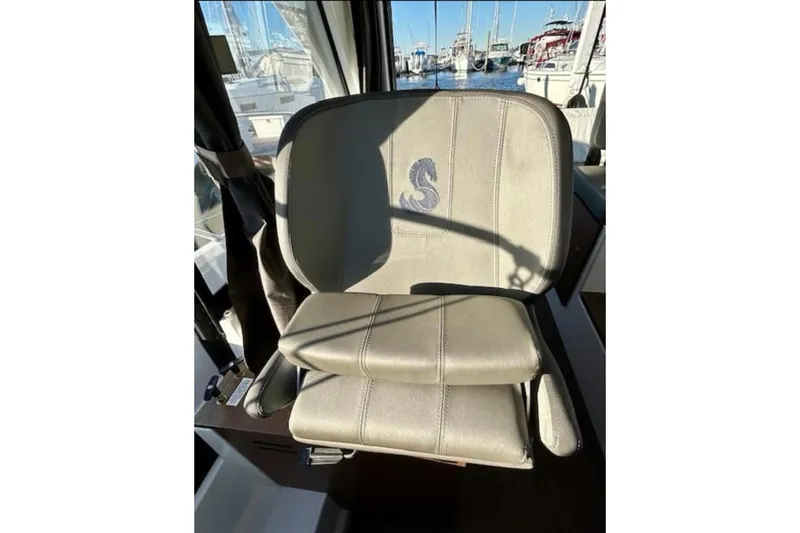 Slide: The Image of Captain's seat on 2024 Beneteau Antares 9 boat, featuring embroidered logo. - 14