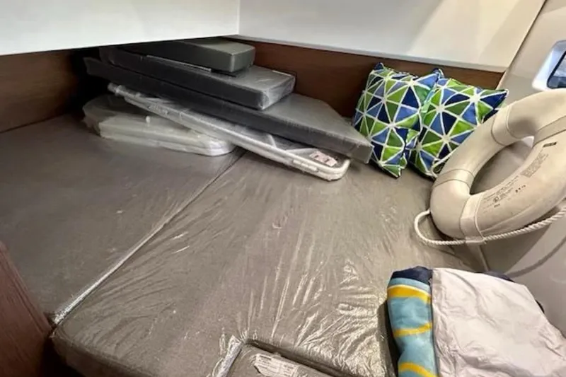 Slide: The Image of 2024 Beneteau Antares 9 cabin interior with cushions and life preserver. - 18