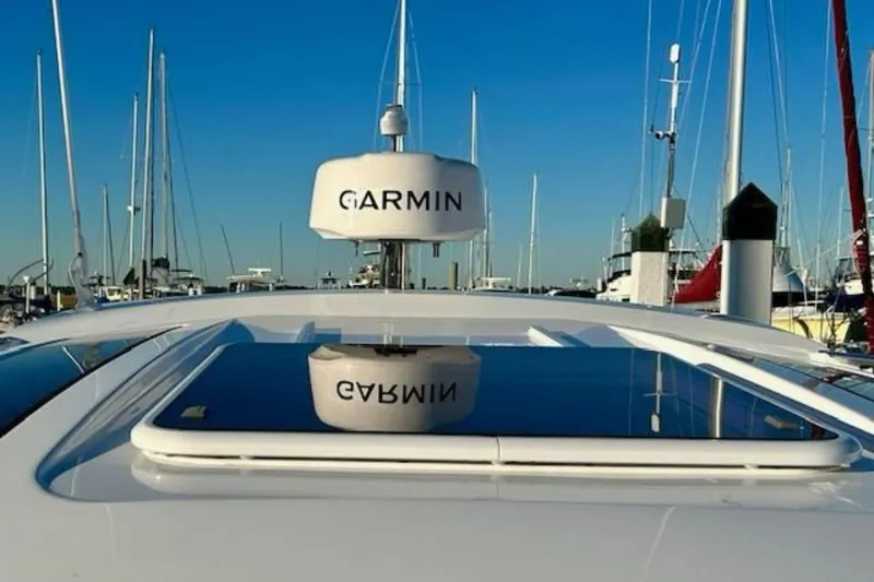 Slide: The Image of 2024 Beneteau Antares 9 with Garmin radar, docked in a marina under clear blue skies. - 20