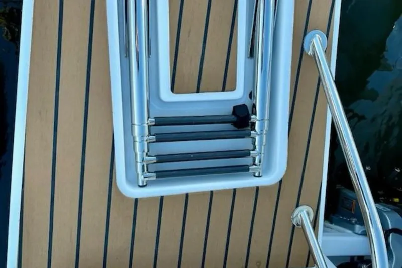 Slide: The Image of 2024 Beneteau Antares 9 swim platform with retractable ladder and teak decking. - 21
