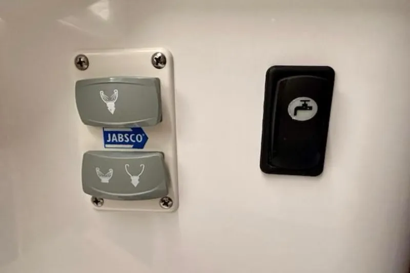 Slide: The Image of Control panel with Jabsco switches on a 2024 Beneteau Antares 9 boat. - 23