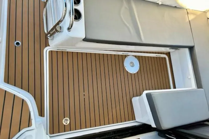 Slide: The Image of 2024 Beneteau Antares 9 boat deck with cushioned seating and wood finish. - 4