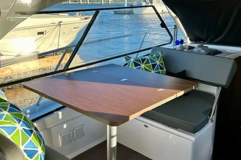 Slide: The Image of Interior of 2024 Beneteau Antares 9 yacht with dining area and colorful cushions. - 5