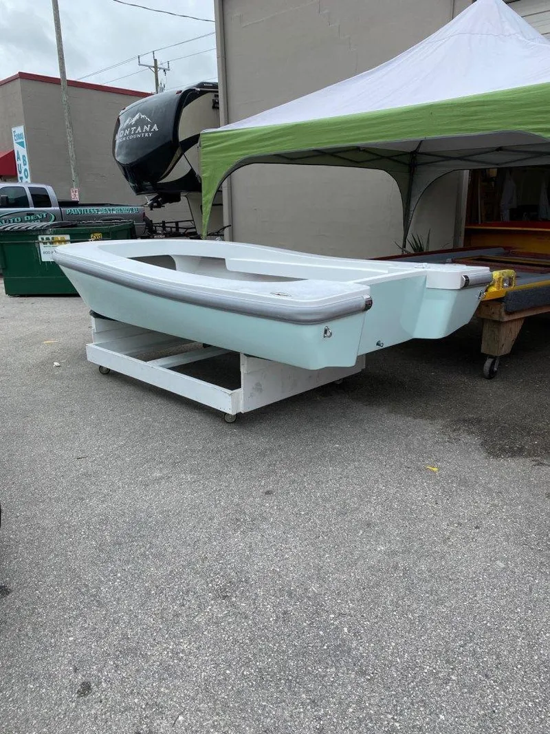 Slide: The Image of 2024 Ultra Lite Tenders ULT 300 boat displayed outdoors under a tent. - 4