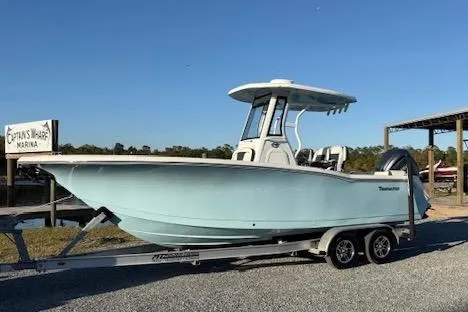 The Image of 2024 Tidewater 232 LXF boat on trailer at marina, side view. - 1