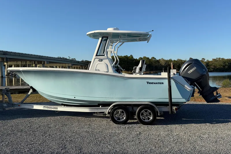 Slide: The Image of 2024 Tidewater 232 LXF boat on trailer by a river, featuring Yamaha outboard motor. - 12
