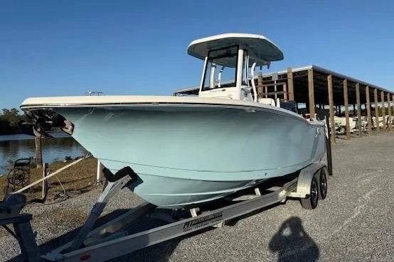 Slide: The Image of 2024 Tidewater 232 LXF boat on trailer, parked outdoors under clear blue sky. - 3