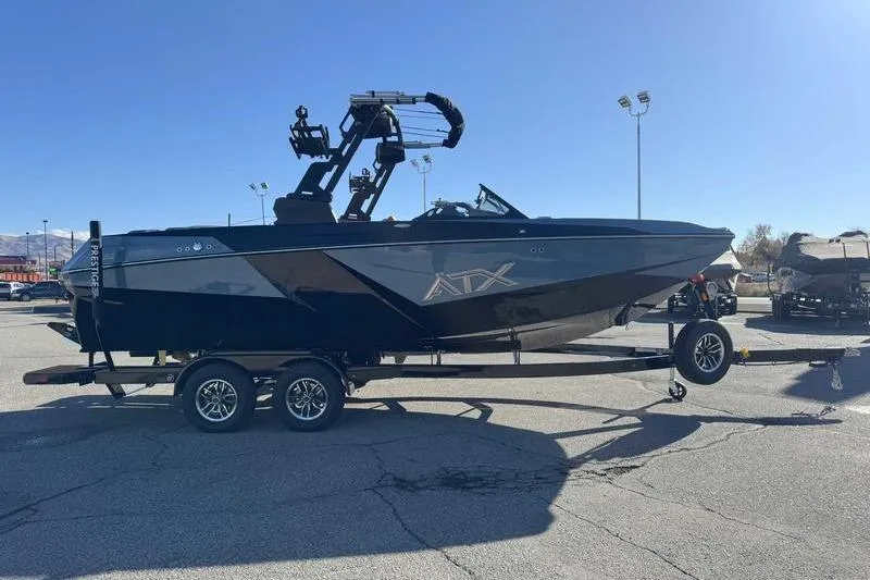 Slide: The Image of 2026 ATX Surf Boats 22 Type-S on trailer in parking lot, sunny day. - 9