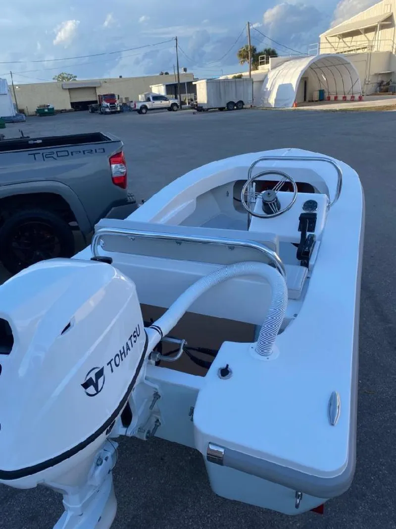 Slide: The Image of 2024 Ultra Lite Tenders ULT 380 boat with Tohatsu motor, parked outdoors. - 7