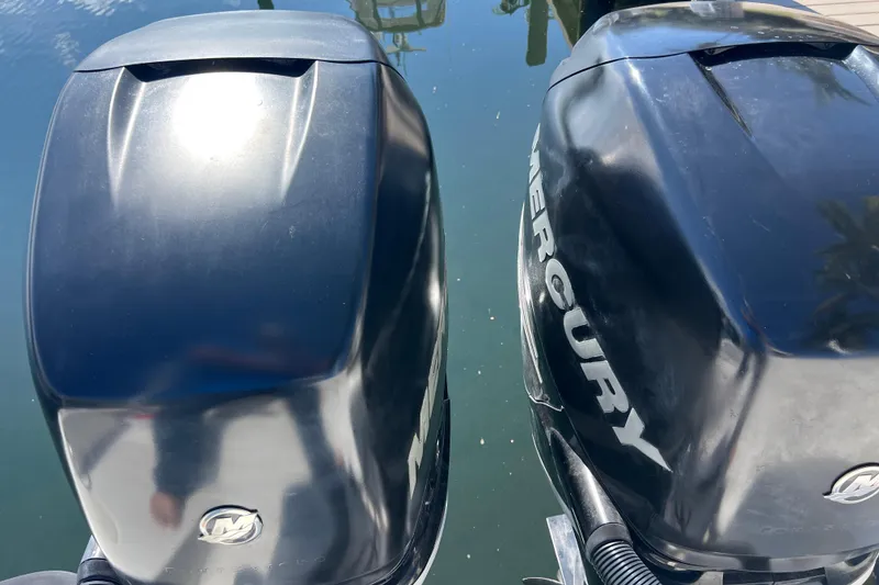 Slide: The Image of Twin Mercury outboard engines on a 2015 Boston Whaler 270 Dauntless boat. - 10