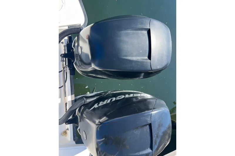 Slide: The Image of Twin Mercury outboard engines on a 2015 Boston Whaler 270 Dauntless boat. - 11