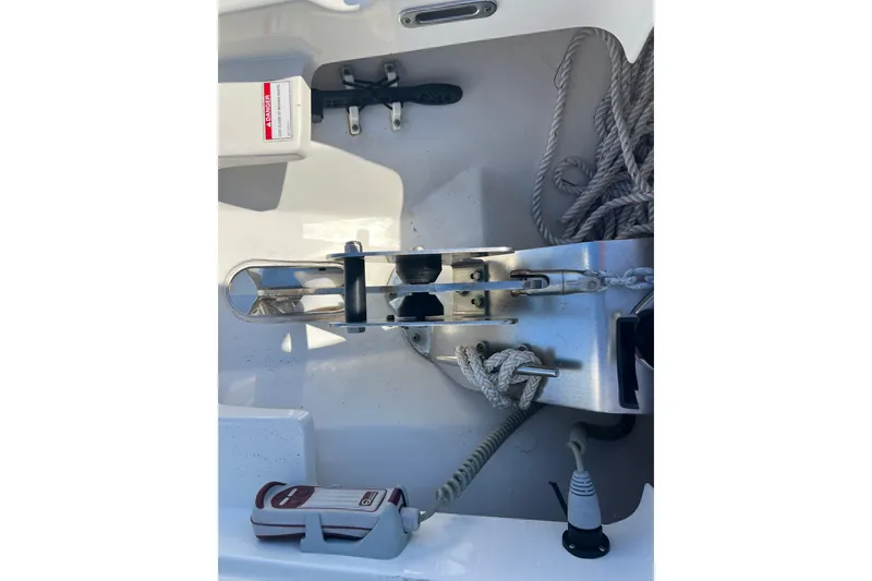 Slide: The Image of 2015 Boston Whaler 270 Dauntless anchor compartment with ropes and hardware. - 17
