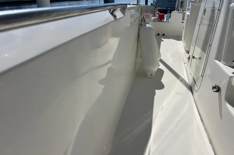Slide: The Image of 2015 Boston Whaler 270 Dauntless boat deck with fenders and clean white surface. - 22