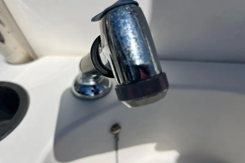Slide: The Image of Close-up of a faucet on a 2015 Boston Whaler 270 Dauntless boat. - 29