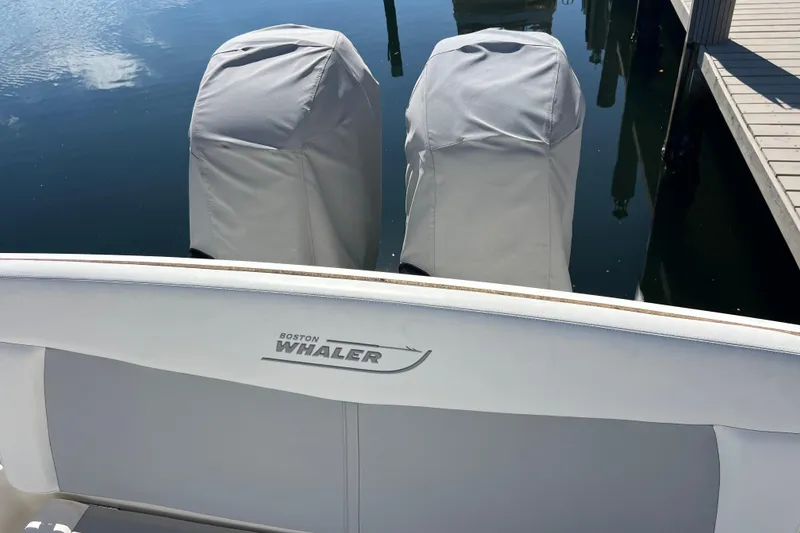 Slide: The Image of 2015 Boston Whaler 270 Dauntless boat with covered engines at dock. - 34