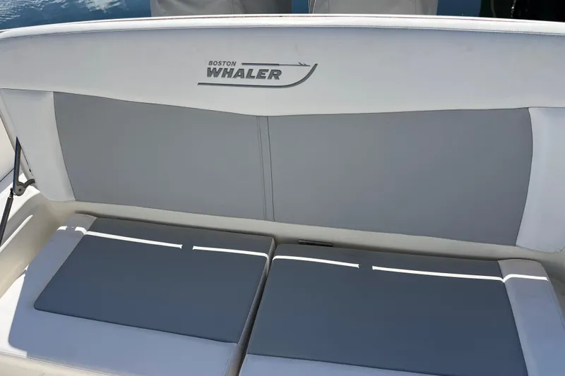 Slide: The Image of Boston Whaler 270 Dauntless 2015 boat seating with logo, featuring gray and white upholstery. - 35