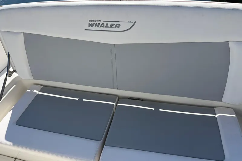 Slide: The Image of Boston Whaler 270 Dauntless 2015 boat seating with logo, featuring cushioned backrest. - 37